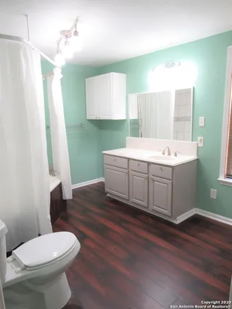 a bathroom with a sink toilet and mirror