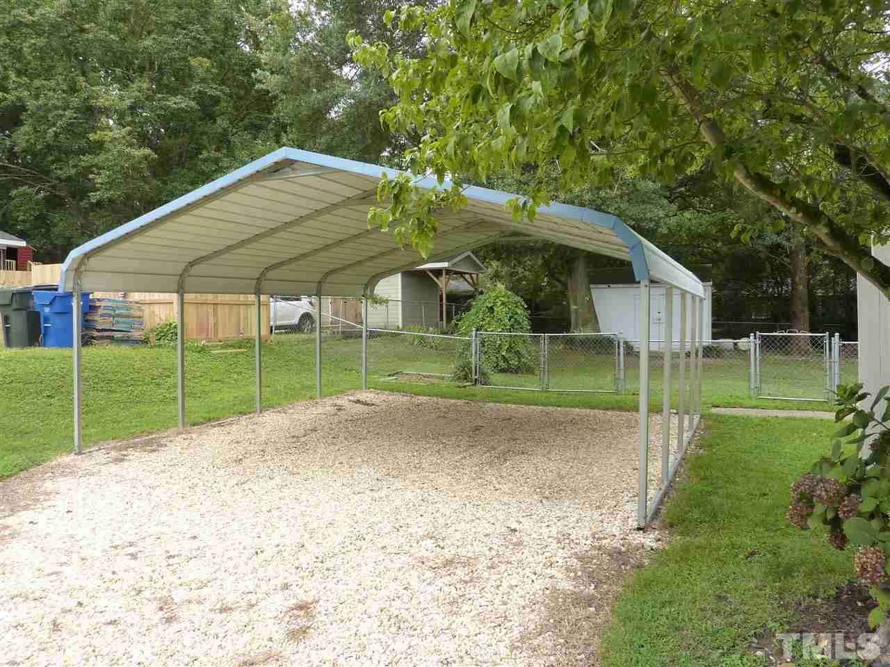 7201 Perry Creek Road Raleigh, NC 27616 - Photo 13 of 16 Two car carport at the end of a gravel driveway.