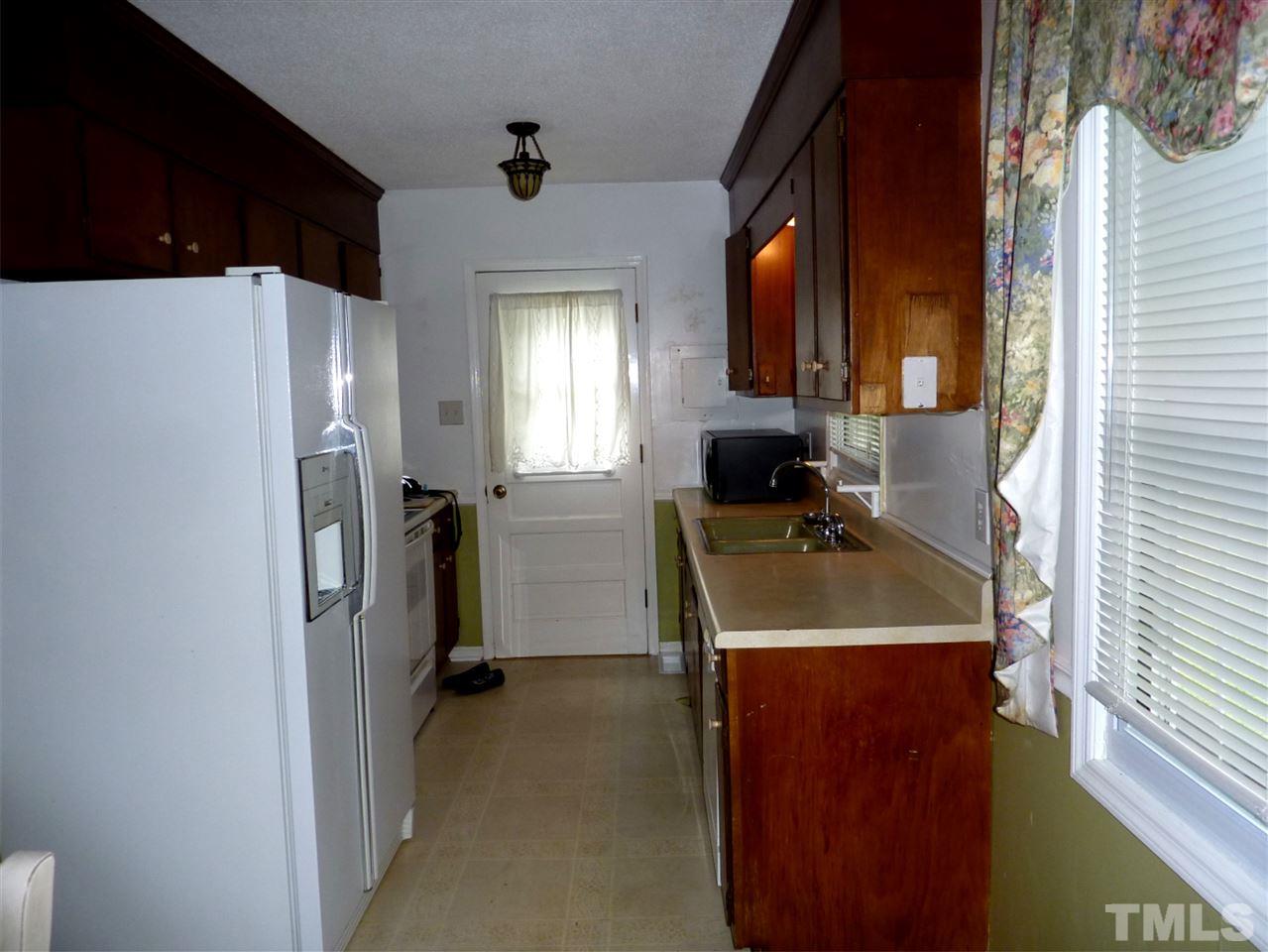 7201 Perry Creek Road Raleigh, NC 27616 - Photo 5 of 16 Kitchen offers lots of cabinets, electric appliances, and a large 2 bay sink.