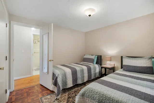 a bedroom with two beds and a window