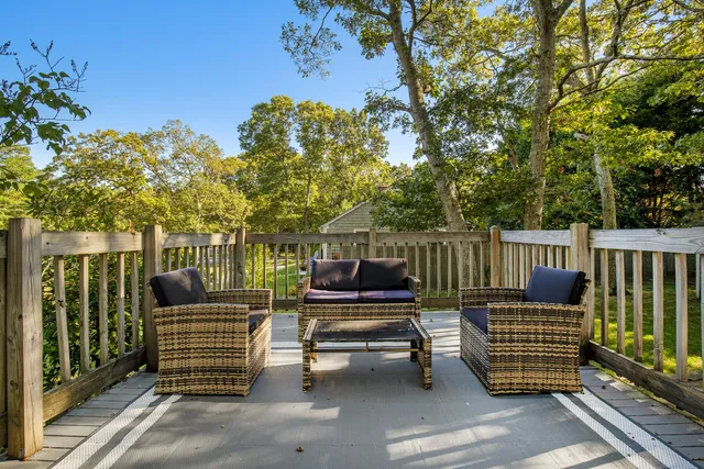 a view of a house with a small yard and wooden fence