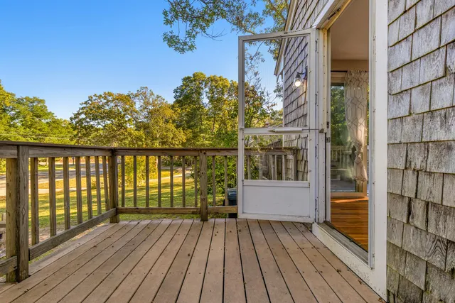 a view of a balcony with wooden floor