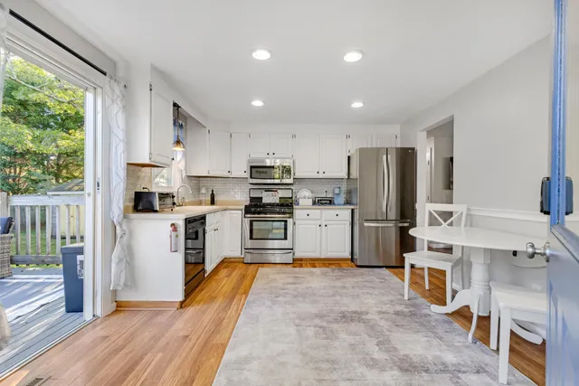 a kitchen with stainless steel appliances granite countertop a refrigerator sink and cabinets