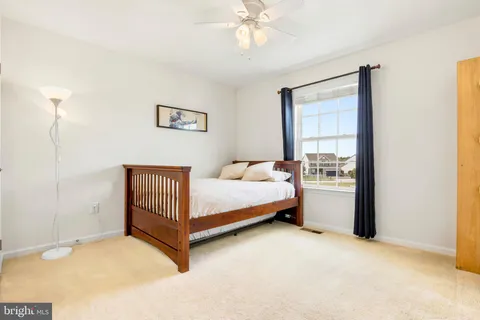 a spacious bedroom with a bed and a window