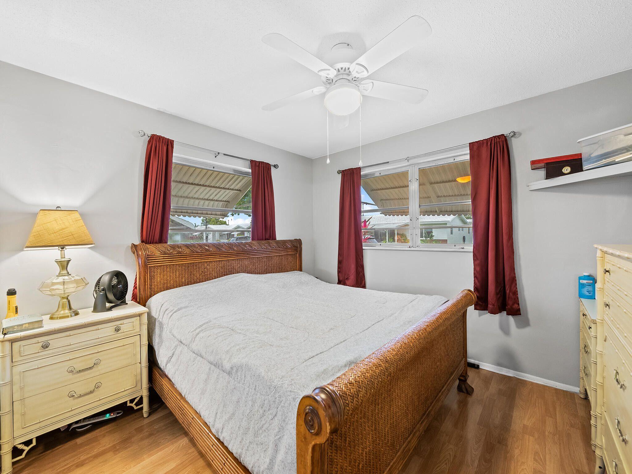 210 Northwest 25th Court Pompano Beach, FL 33064 - Photo 12 of 17 a bedroom with a bed and a dresser