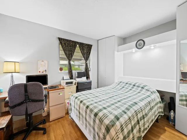 a bedroom with a bed and a large window