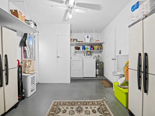 a utility room with cabinets dryer and washer
