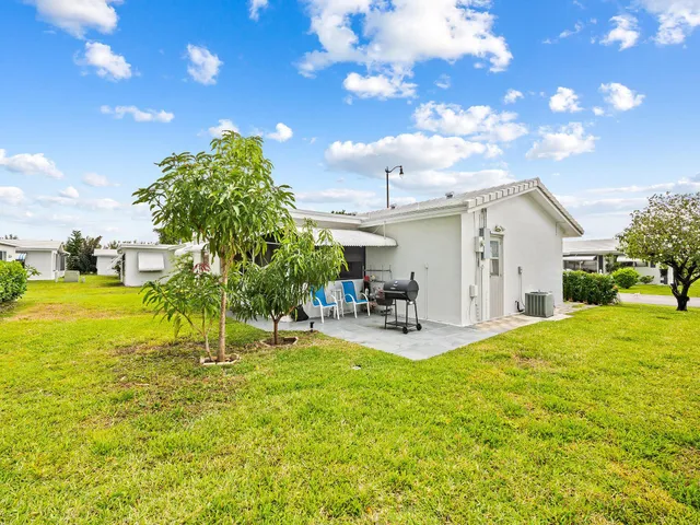 a view of a house with backyard porch and sitting area