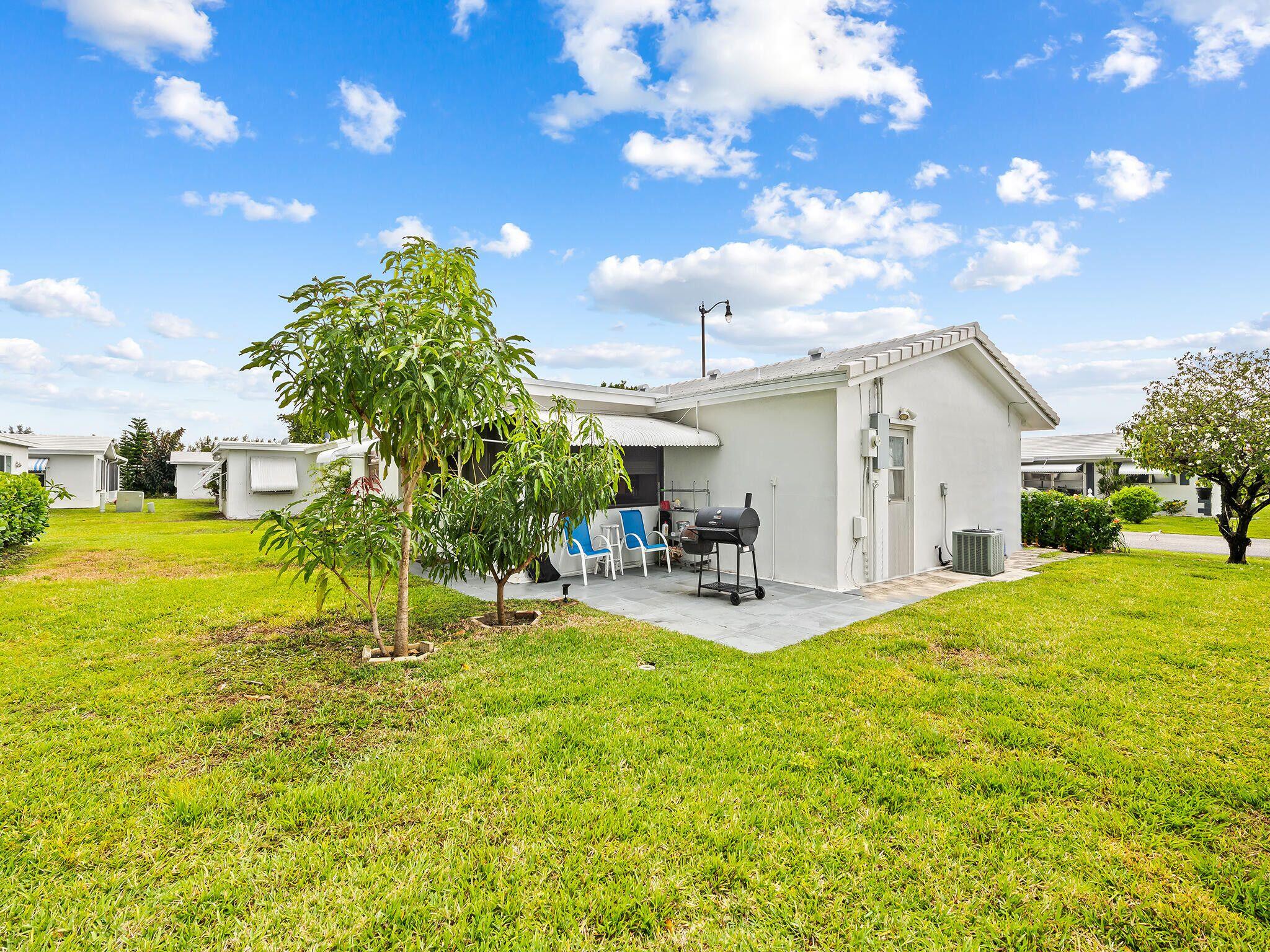 210 Northwest 25th Court Pompano Beach, FL 33064 - Photo 3 of 17 a view of a house with backyard porch and sitting area