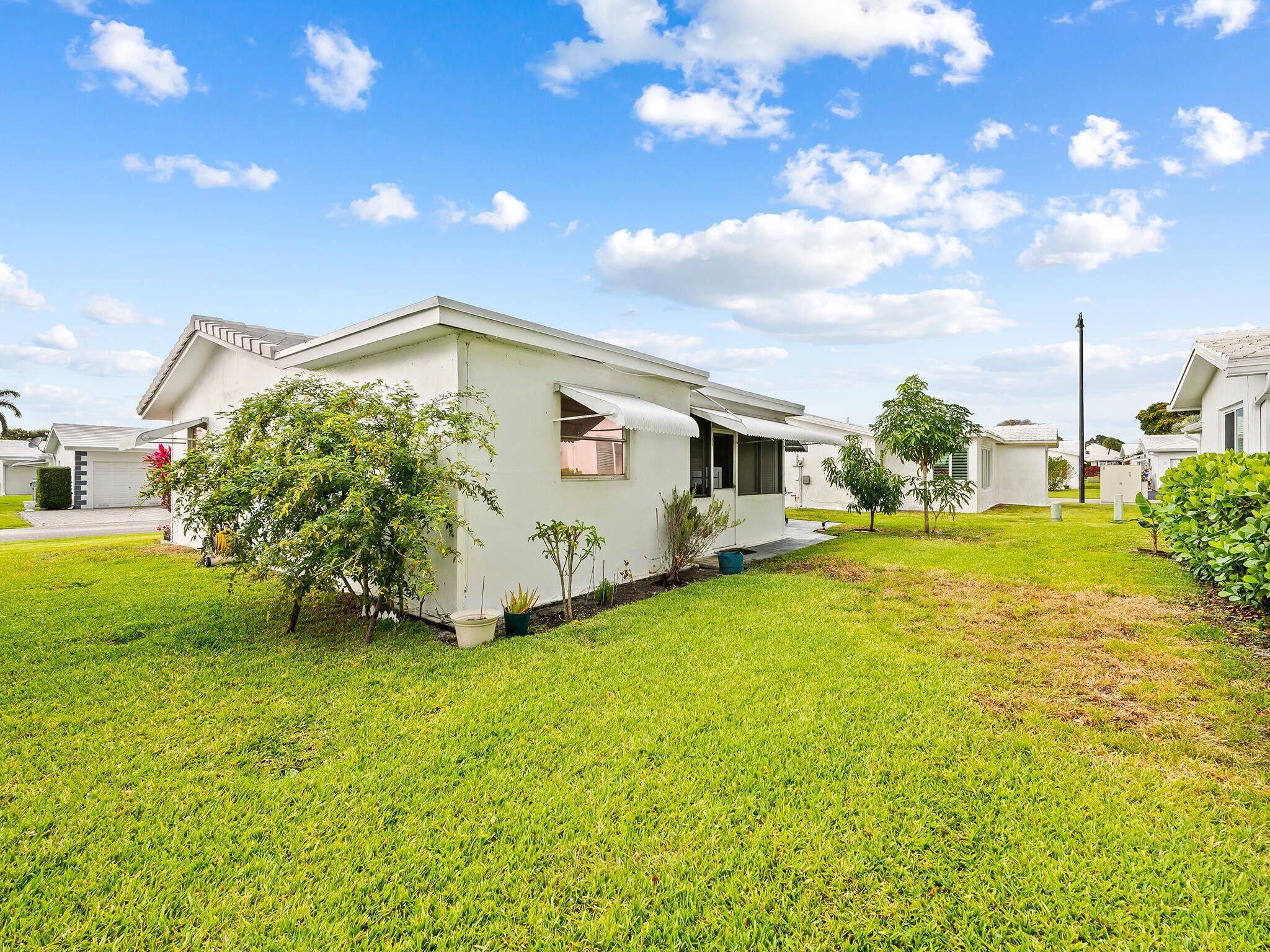 210 Northwest 25th Court Pompano Beach, FL 33064 - Photo 4 of 17 a front view of a house with garden