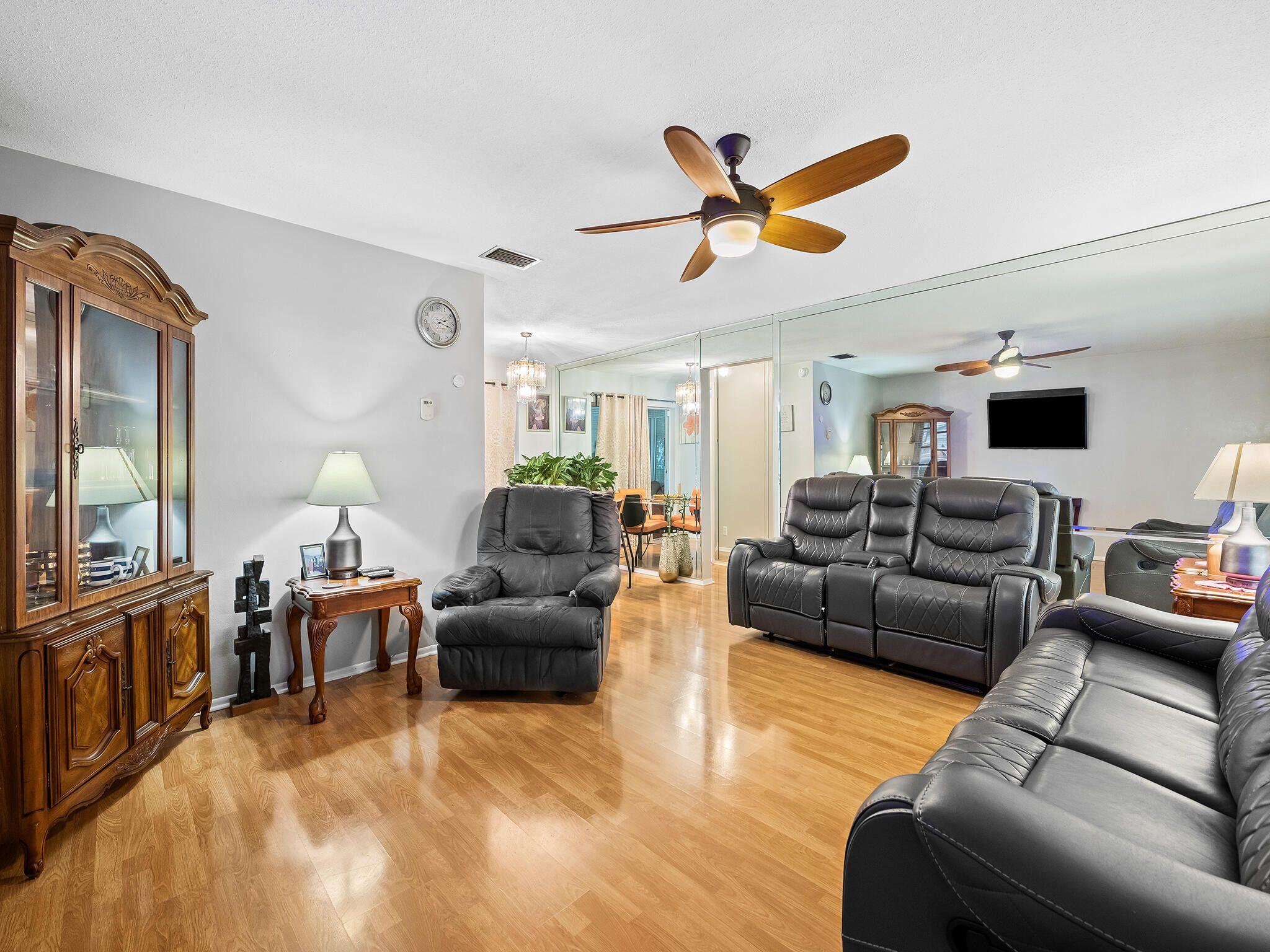 210 Northwest 25th Court Pompano Beach, FL 33064 - Photo 5 of 17 a living room with furniture and a flat screen tv