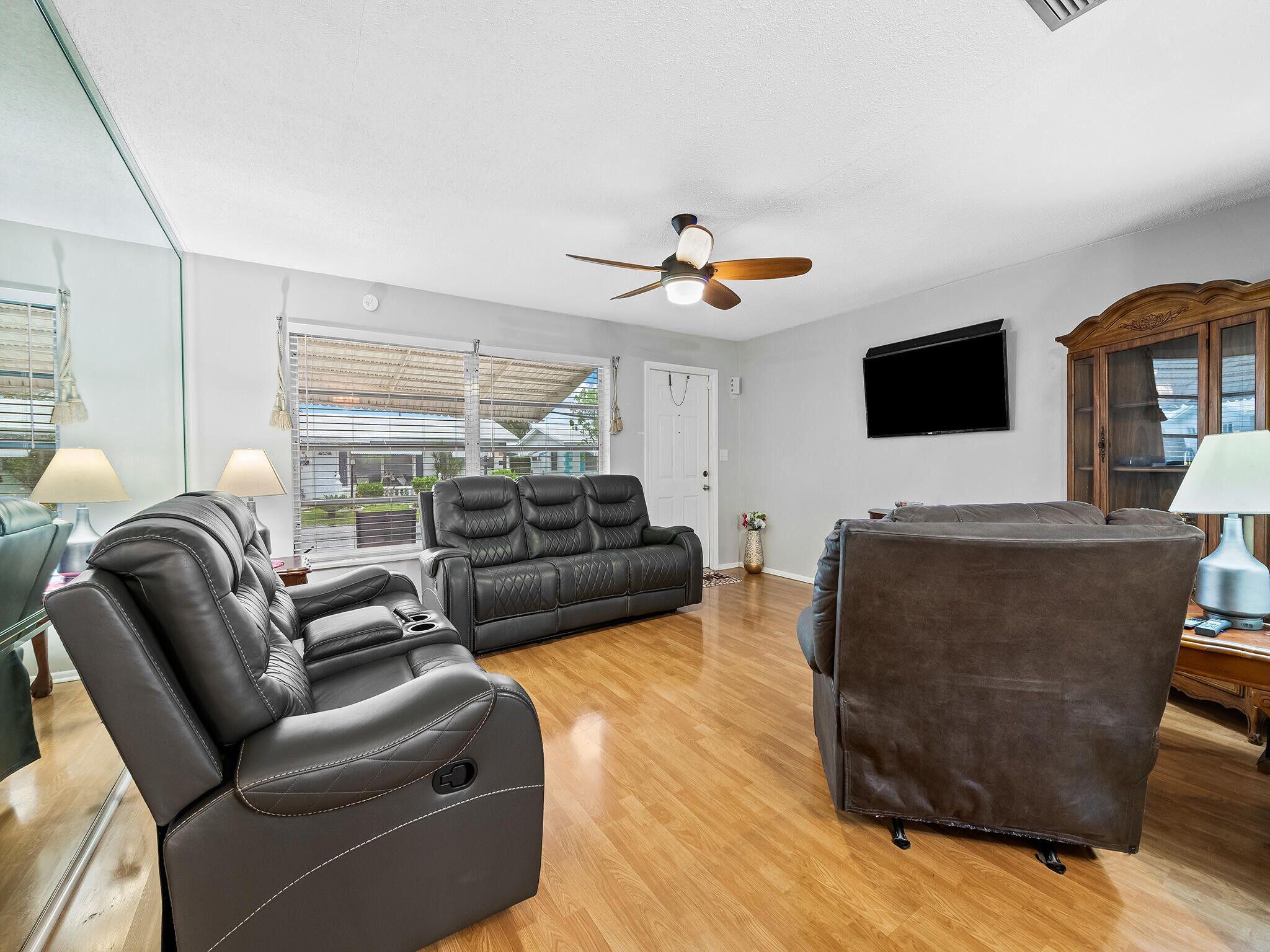 210 Northwest 25th Court Pompano Beach, FL 33064 - Photo 6 of 17 a living room with furniture and a flat screen tv