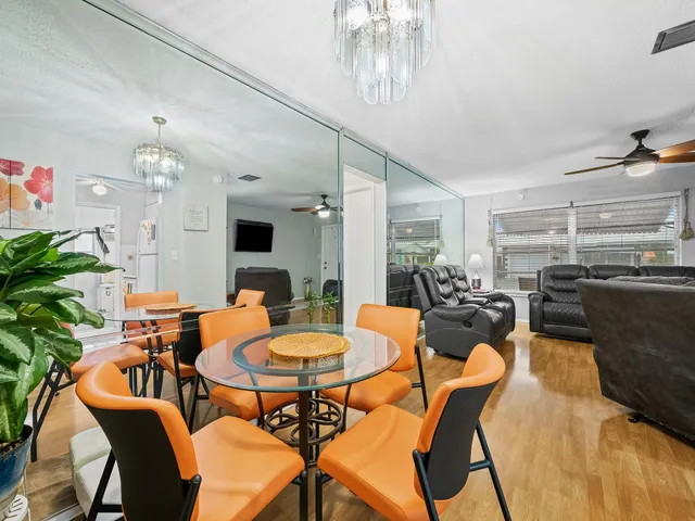 a view of a dining room with furniture and a chandelier