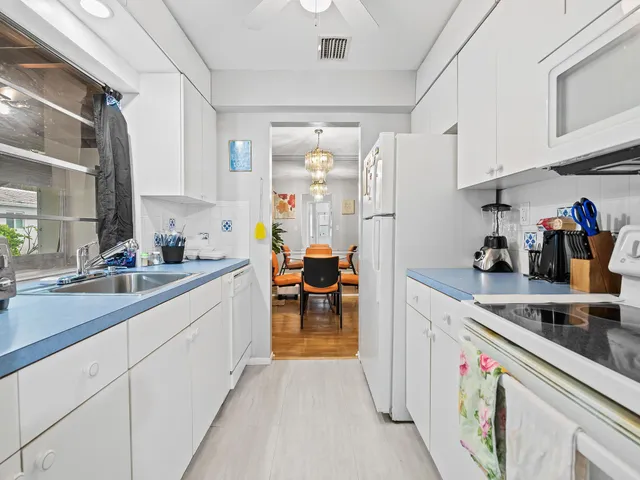a kitchen with sink and cabinets