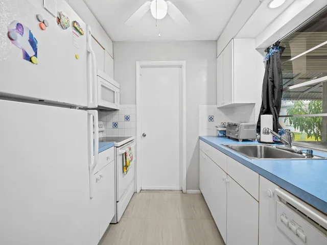 a kitchen with a sink stove and refrigerator