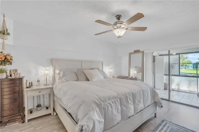 a bedroom with a large bed and a chandelier