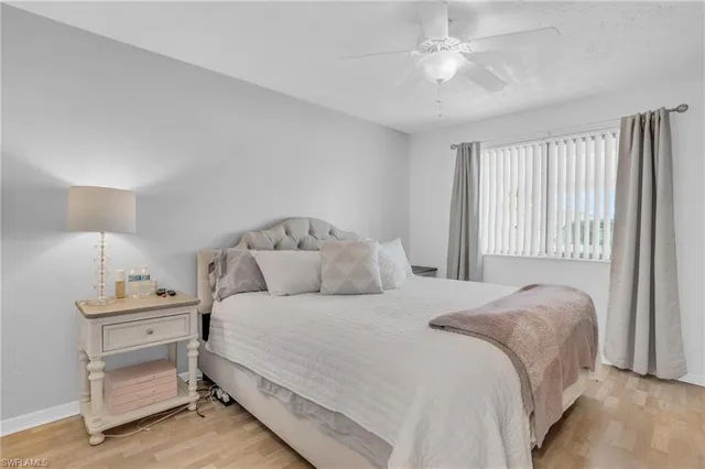 a bedroom with a bed and a ceiling fan