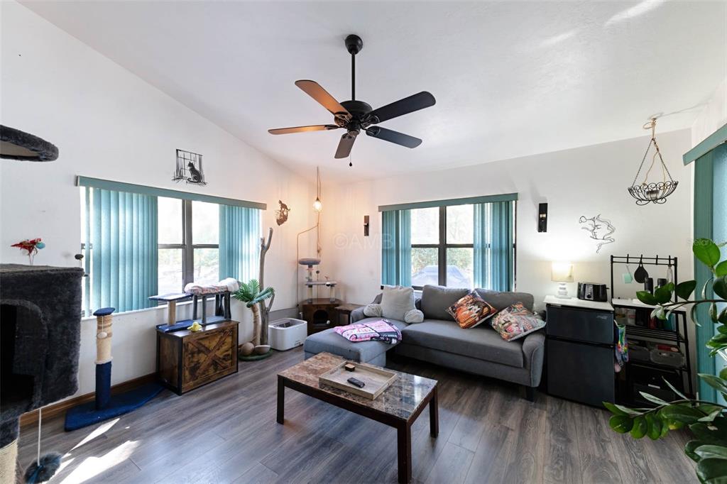 2298 West Pine Ridge Boulevard Beverly Hills, FL 34465 - Photo 13 of 34 a living room with furniture ceiling fan and a window