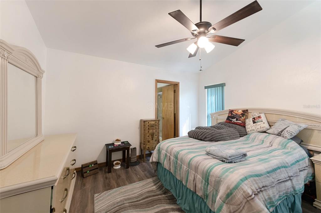 2298 West Pine Ridge Boulevard Beverly Hills, FL 34465 - Photo 15 of 34 a bedroom with a bed and a table