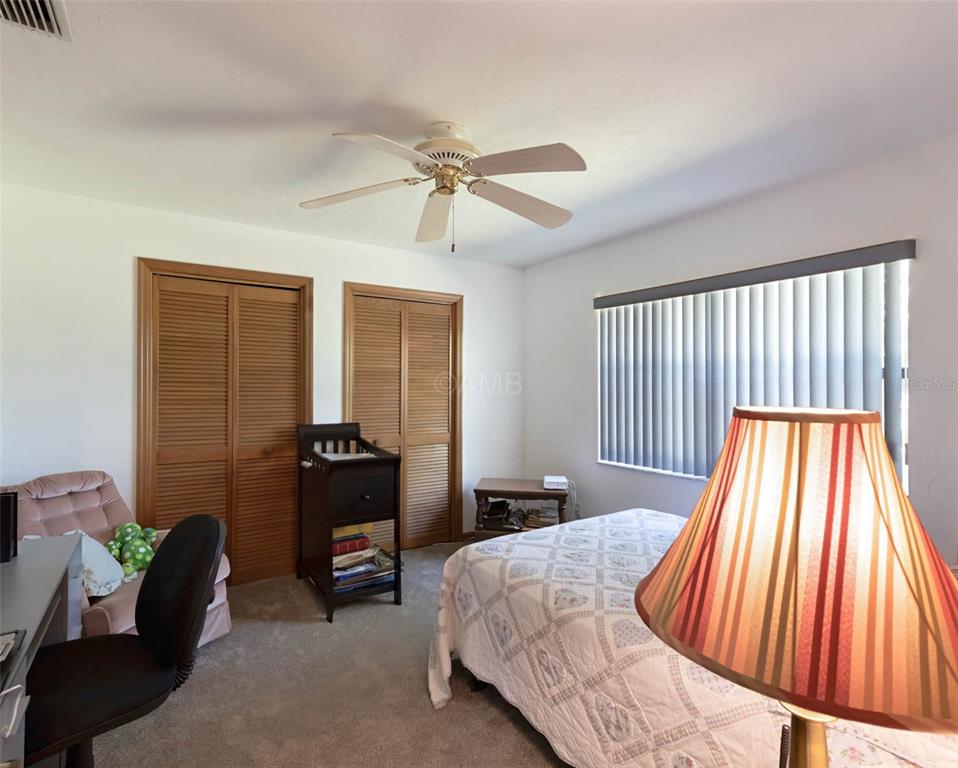 2298 West Pine Ridge Boulevard Beverly Hills, FL 34465 - Photo 16 of 34 a bedroom with a bed and a balcony view