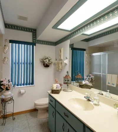 a spacious bathroom with a double vanity sink a mirror a bathtub and next to a window