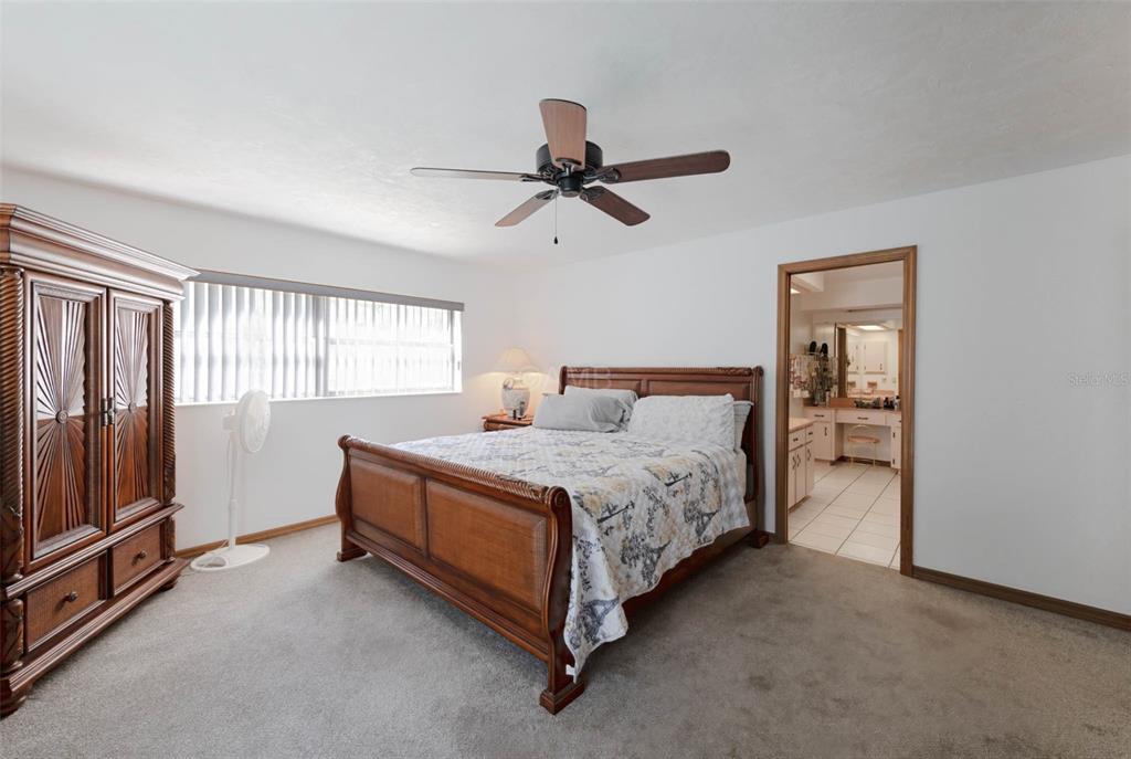 2298 West Pine Ridge Boulevard Beverly Hills, FL 34465 - Photo 20 of 34 a spacious bedroom with a bed and a window