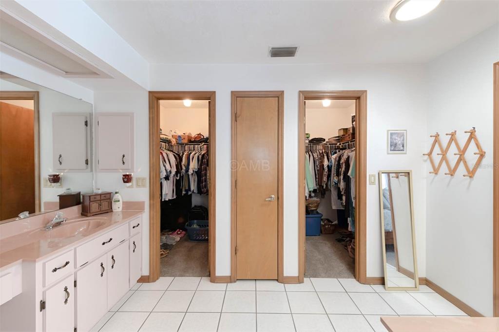 2298 West Pine Ridge Boulevard Beverly Hills, FL 34465 - Photo 24 of 34 a bathroom with a granite countertop shower a sink and a mirror
