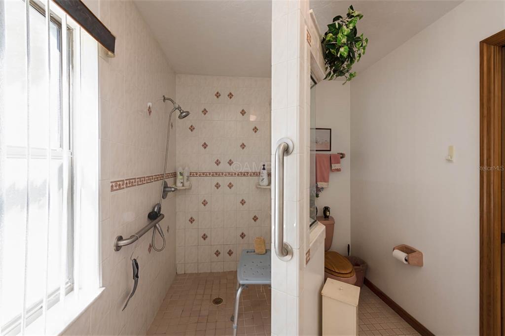 2298 West Pine Ridge Boulevard Beverly Hills, FL 34465 - Photo 25 of 34 a bathroom with a shower