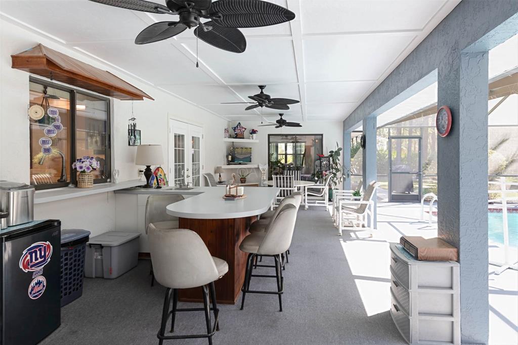 2298 West Pine Ridge Boulevard Beverly Hills, FL 34465 - Photo 29 of 34 a dining room with wooden floor a chandelier a wooden table and chairs
