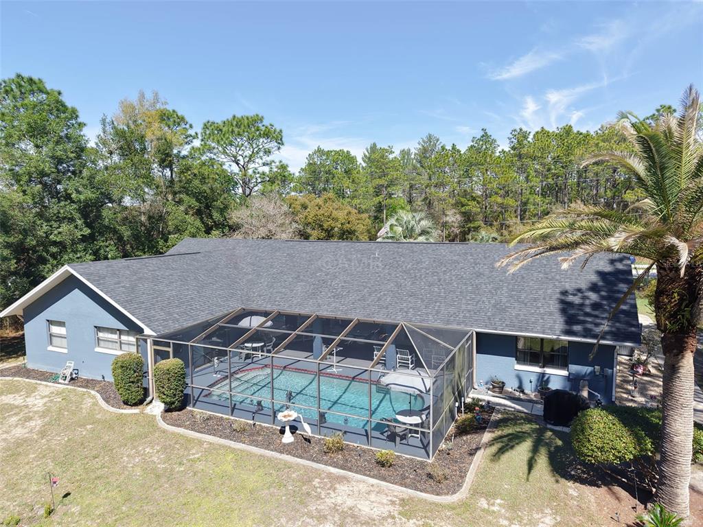 2298 West Pine Ridge Boulevard Beverly Hills, FL 34465 - Photo 33 of 34 an aerial view of a house with yard swimming pool and outdoor seating
