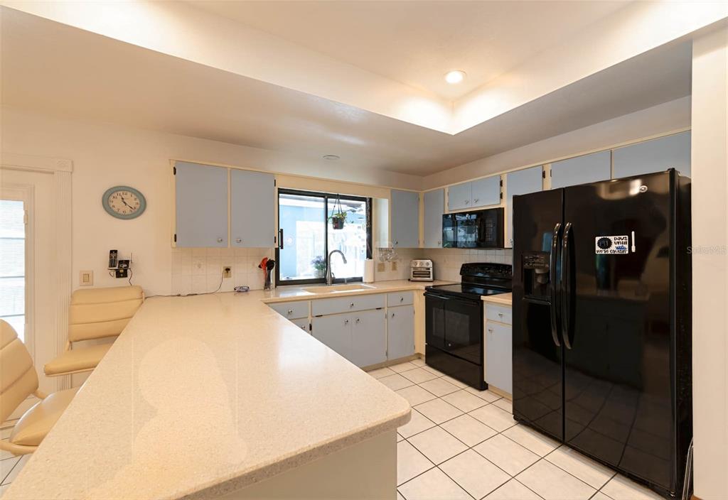 2298 West Pine Ridge Boulevard Beverly Hills, FL 34465 - Photo 9 of 34 a large kitchen with a stove a refrigerator and a sink