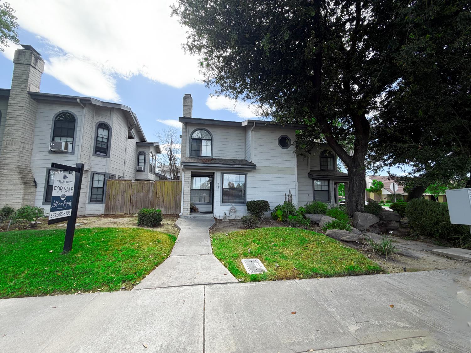 505 South Del Norte Avenue Kerman, CA 93630 - Photo 2 of 12 a front view of a house with a yard and trees