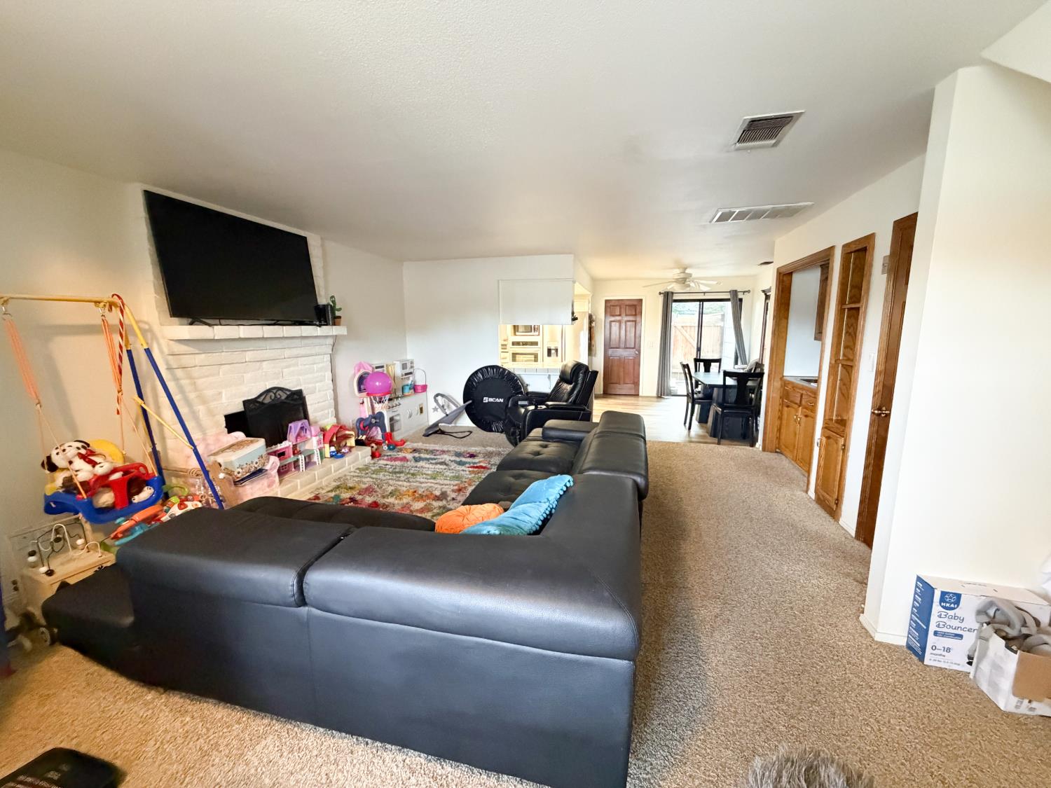 505 South Del Norte Avenue Kerman, CA 93630 - Photo 3 of 12 a living room with furniture and a flat screen tv