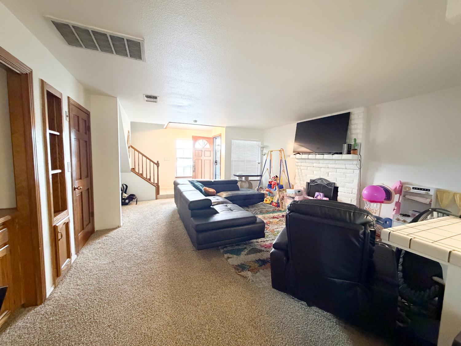 505 South Del Norte Avenue Kerman, CA 93630 - Photo 4 of 12 a living room with furniture and a flat screen tv