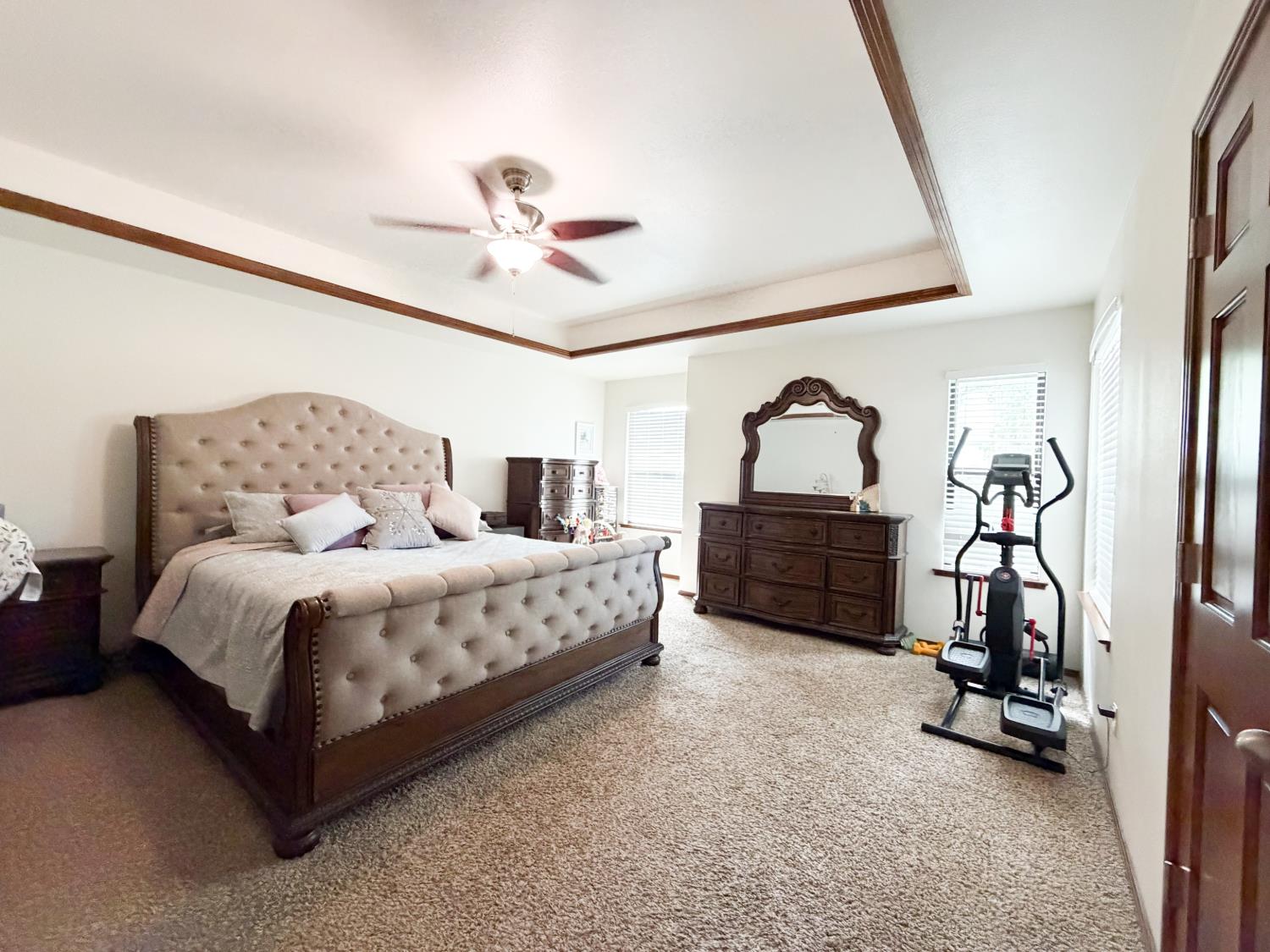 505 South Del Norte Avenue Kerman, CA 93630 - Photo 6 of 12 a bedroom with a bed a couch and a chandelier