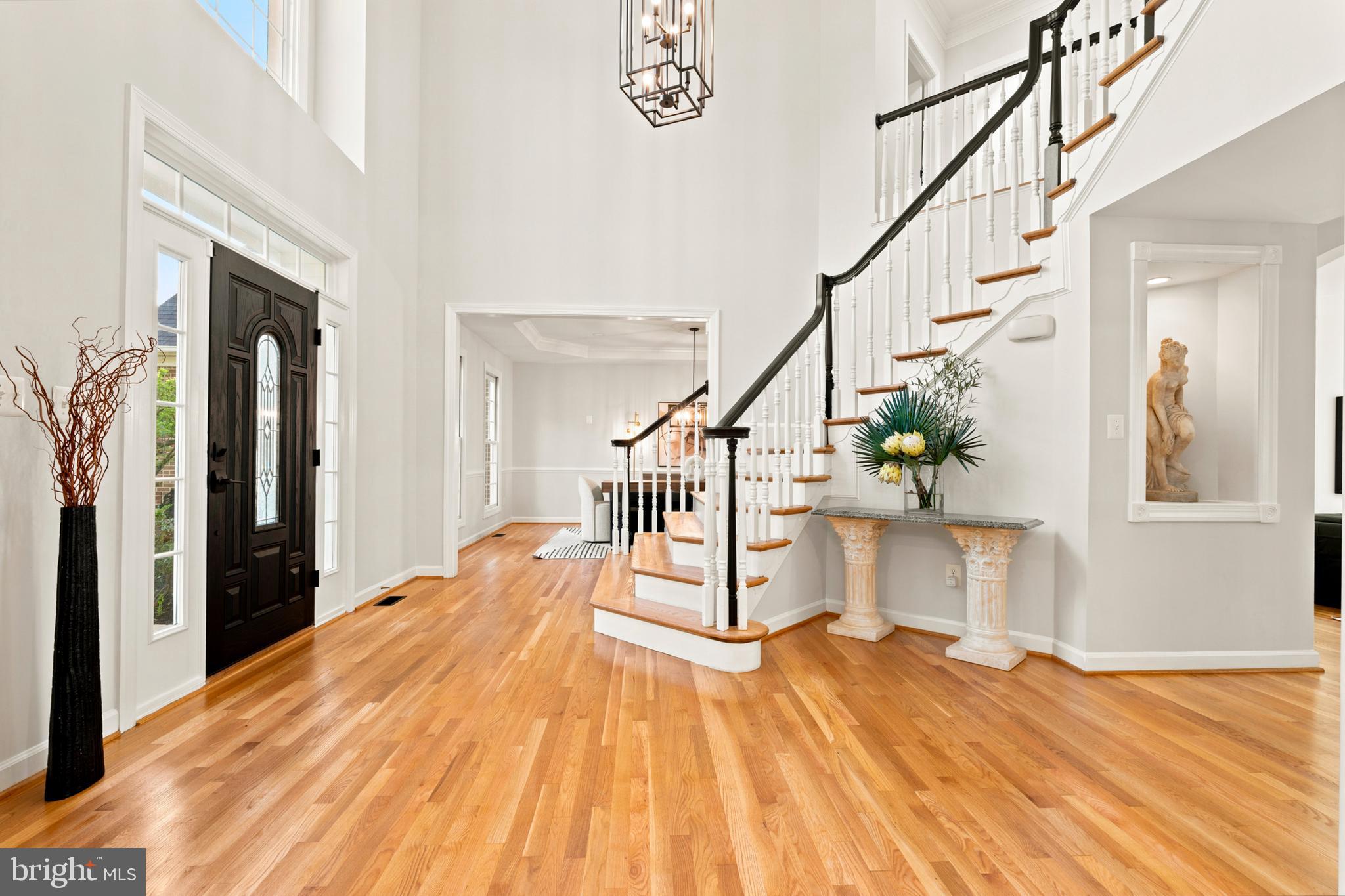 9313 Harrisons Farm Way Laytonsville, MD 20882 - Photo 4 of 77 a view of a hallway with wooden floor and staircase