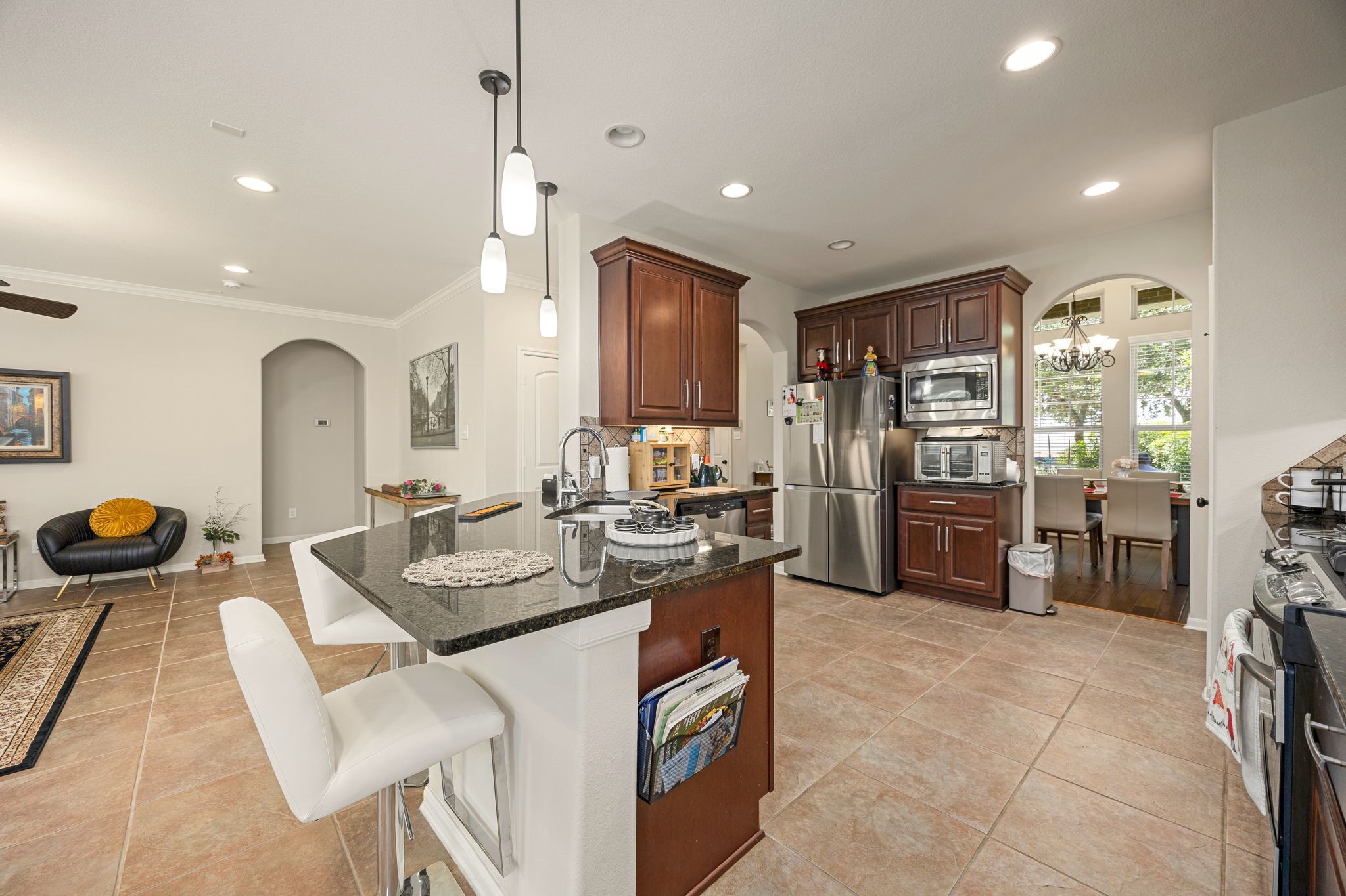 22 South Marshside Place Spring, TX 77389 - Photo 15 of 43 a kitchen with refrigerator and chairs