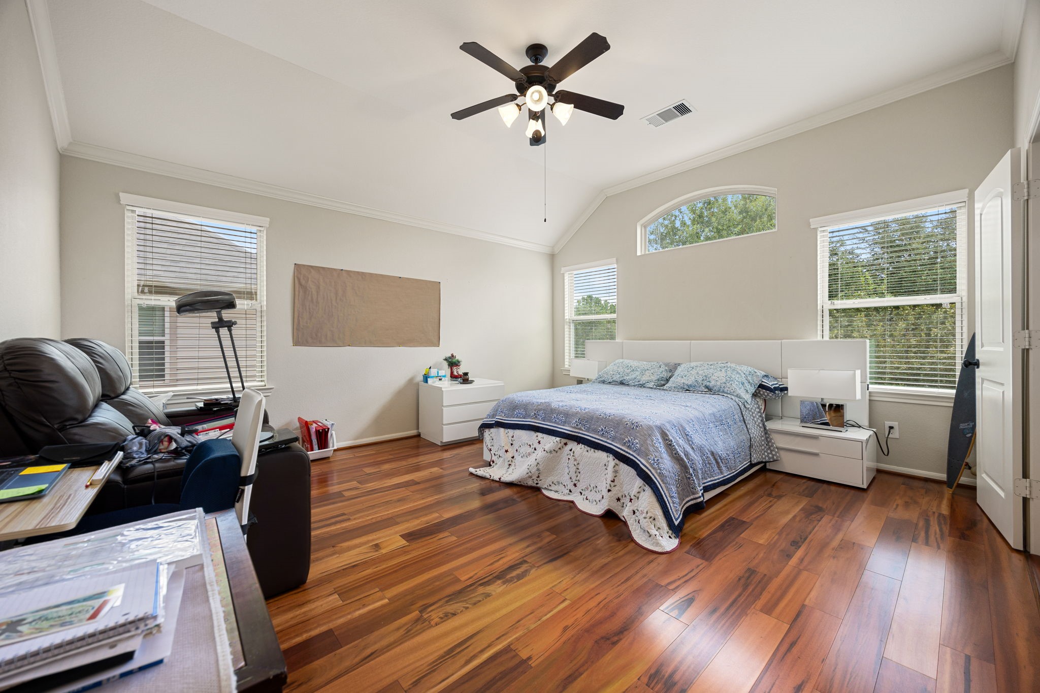 22 South Marshside Place Spring, TX 77389 - Photo 21 of 43 a spacious bedroom with a bed and wooden floor