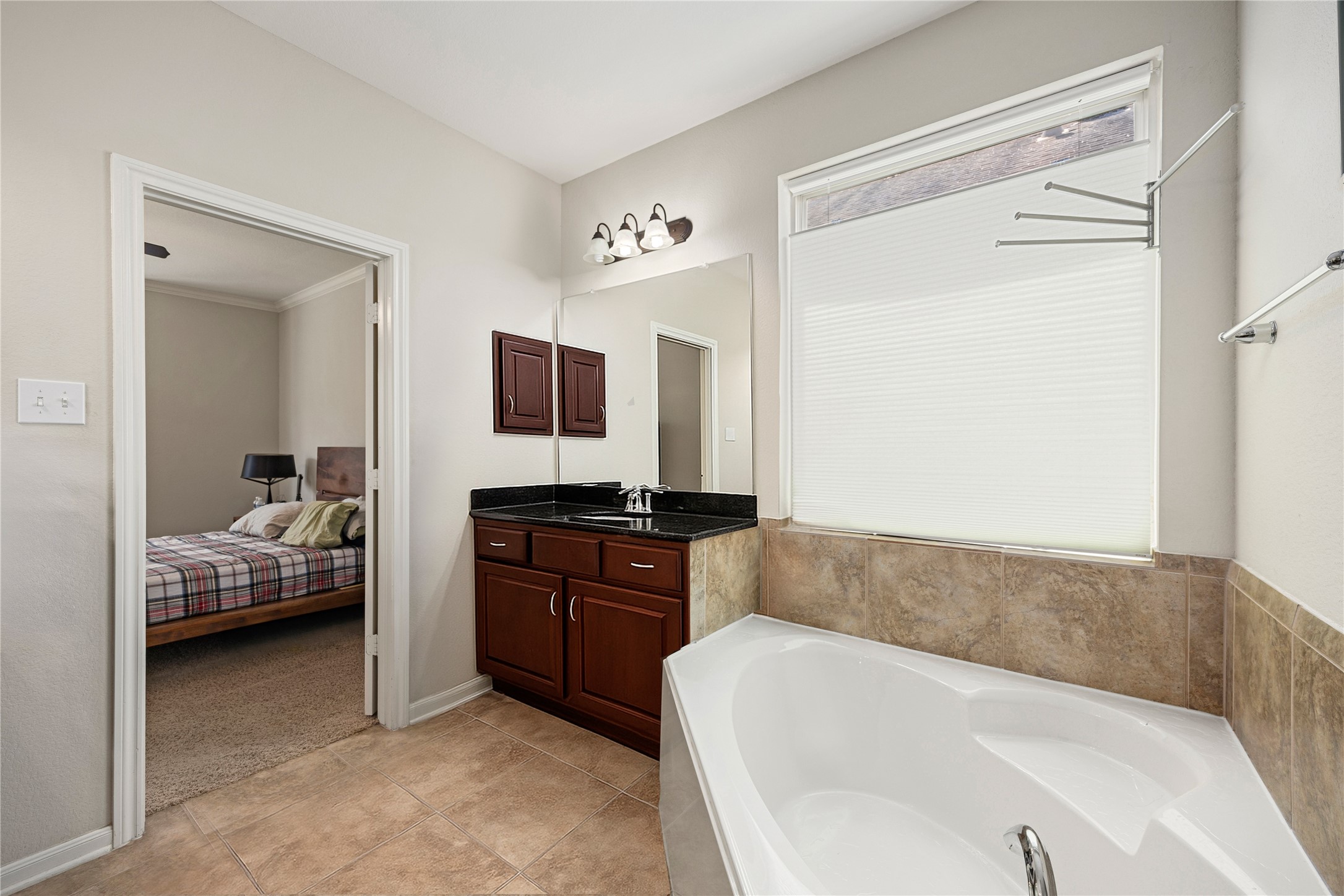 22 South Marshside Place Spring, TX 77389 - Photo 31 of 43 a en suite bathroom with a granite countertop tub and a sink