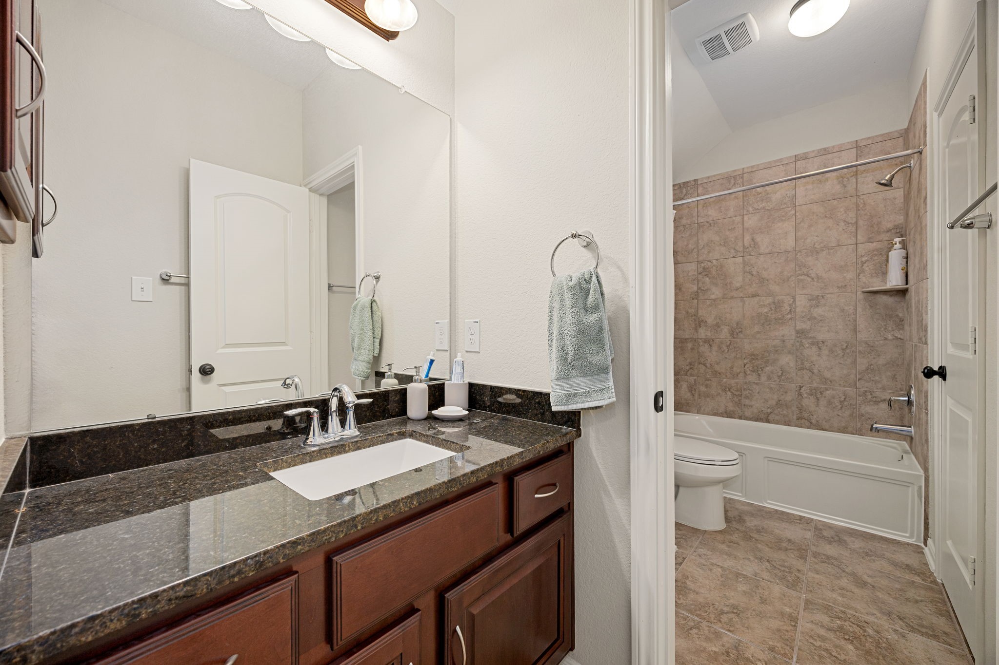 22 South Marshside Place Spring, TX 77389 - Photo 34 of 43 a bathroom with a granite countertop sink and a mirror