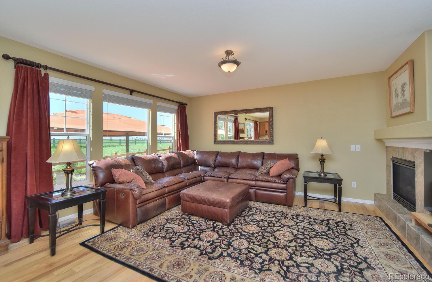 4464 Eagle River Run Broomfield, CO 80023 - Photo 12 of 32 a living room with furniture and a fireplace