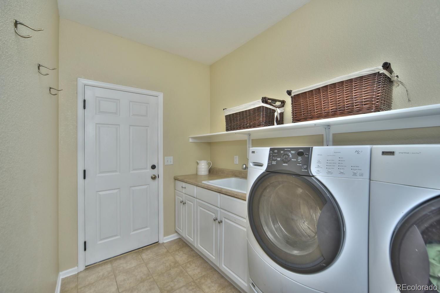 4464 Eagle River Run Broomfield, CO 80023 - Photo 14 of 32 a utility room with dryer and washer