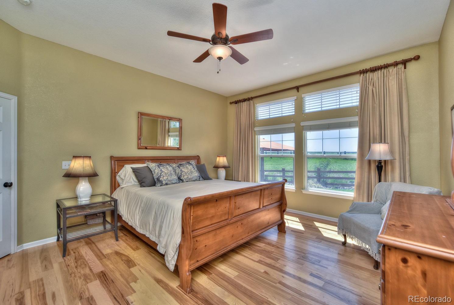 4464 Eagle River Run Broomfield, CO 80023 - Photo 15 of 32 a spacious bedroom with a bed and a couch