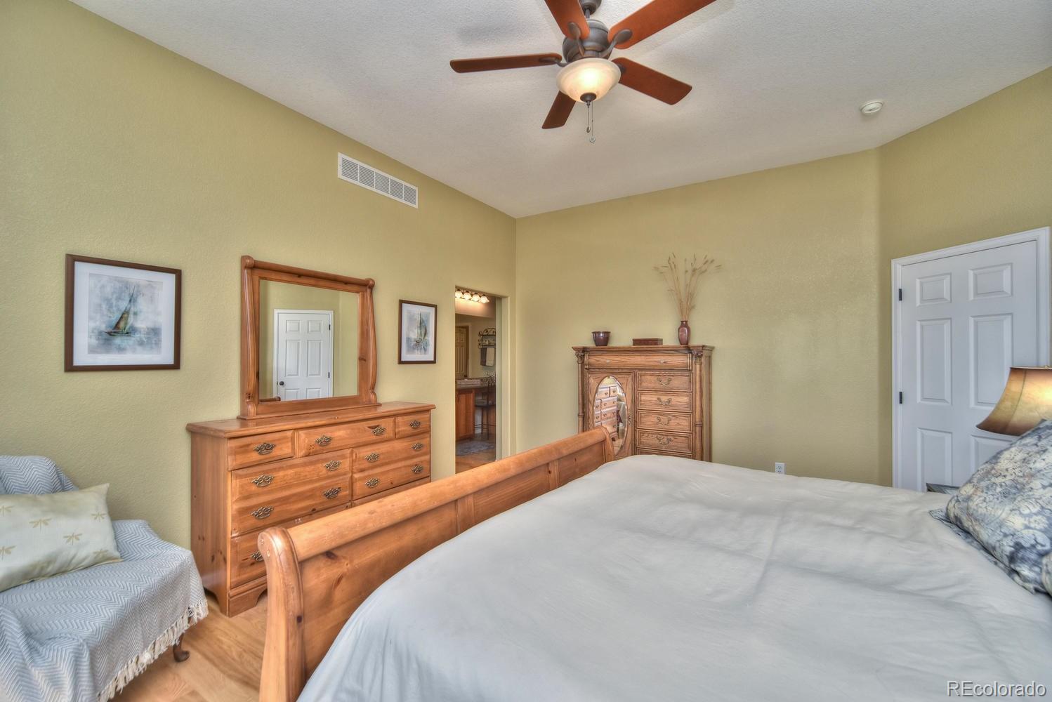 4464 Eagle River Run Broomfield, CO 80023 - Photo 16 of 32 a bedroom with a bed and wooden floor