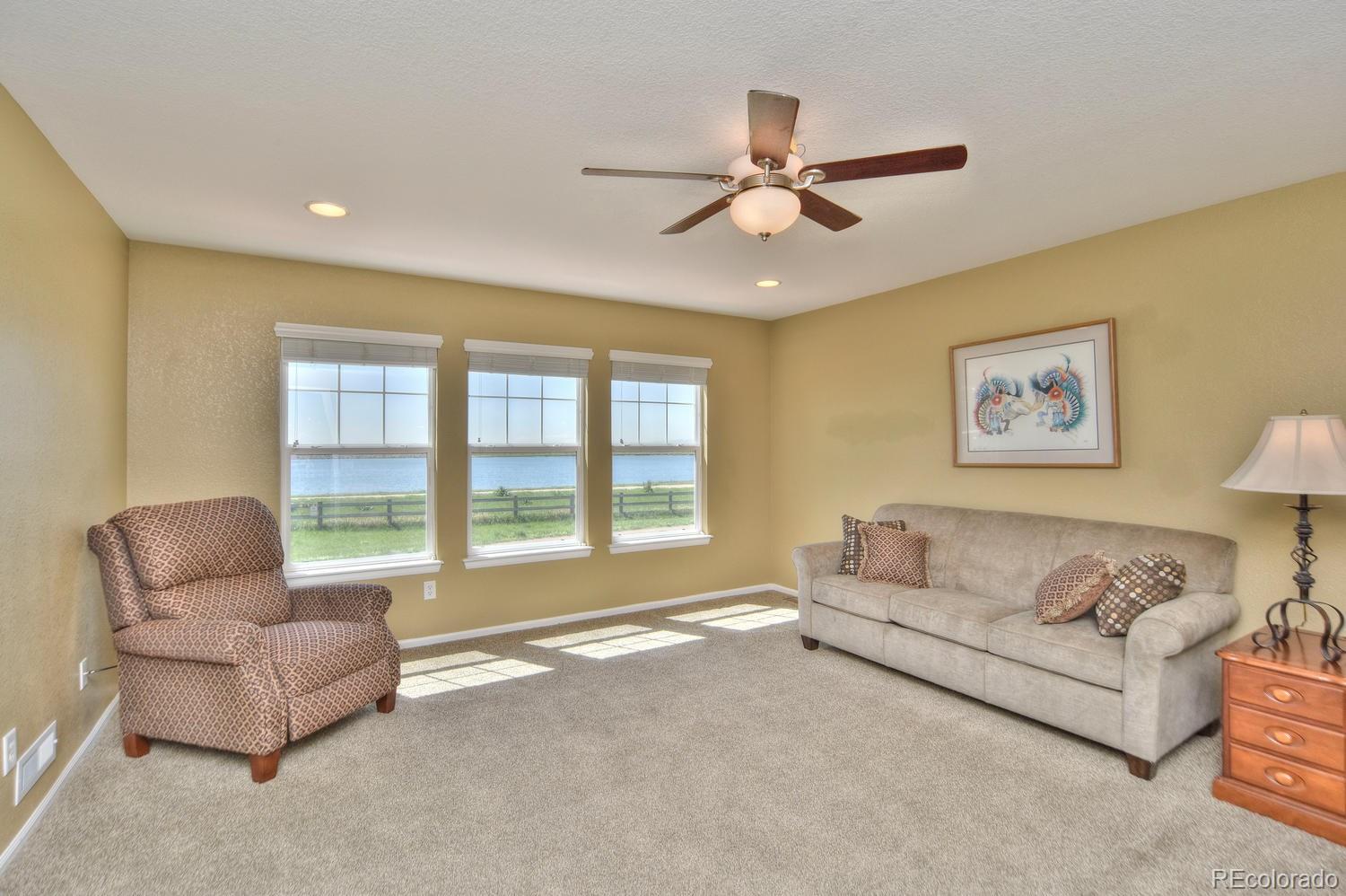 4464 Eagle River Run Broomfield, CO 80023 - Photo 19 of 32 a living room with furniture and a large window