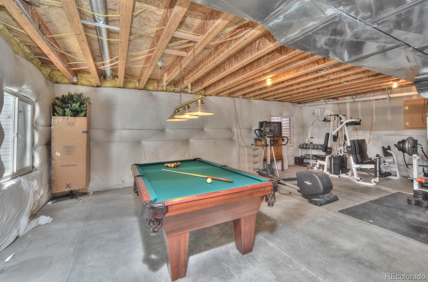 4464 Eagle River Run Broomfield, CO 80023 - Photo 23 of 32 a room with gym equipment and windows