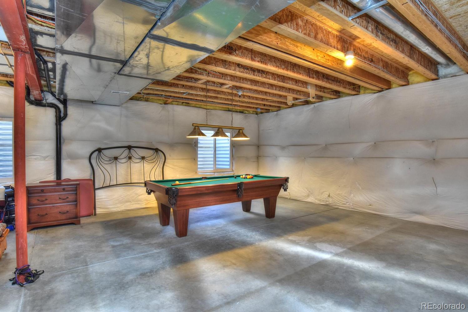 4464 Eagle River Run Broomfield, CO 80023 - Photo 24 of 32 a backyard of a house with table and chairs