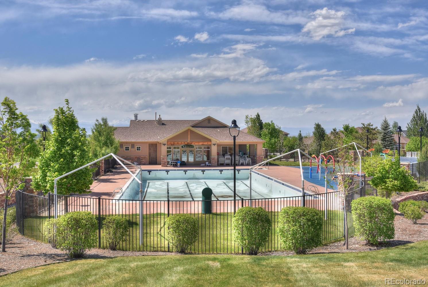 4464 Eagle River Run Broomfield, CO 80023 - Photo 29 of 32 a view of a houses with swimming pool and a yard