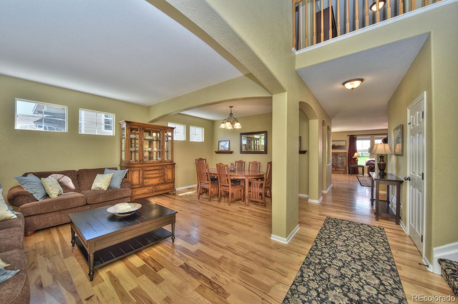 4464 Eagle River Run Broomfield, CO 80023 - Photo 3 of 32 a living room with furniture and a table