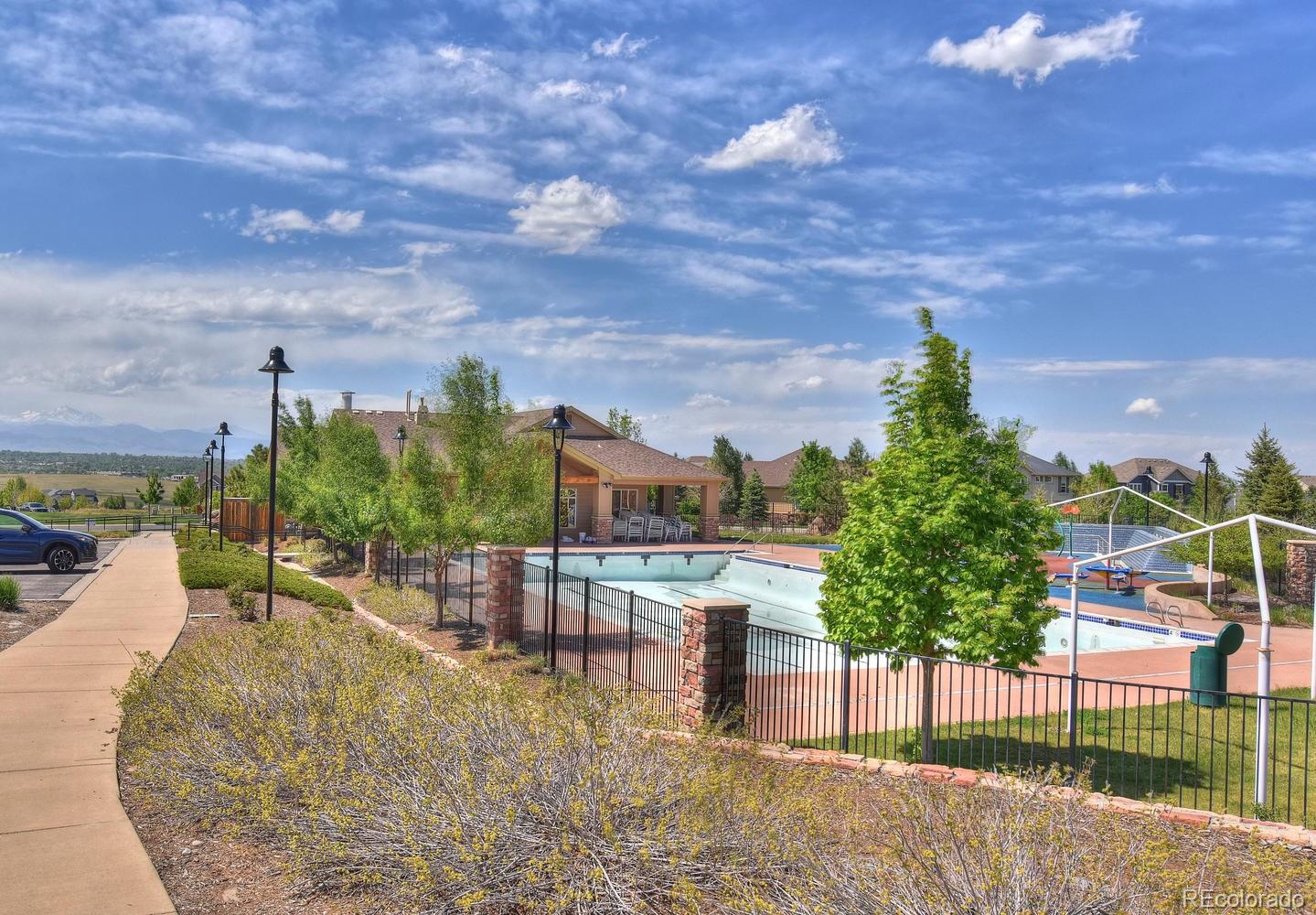 4464 Eagle River Run Broomfield, CO 80023 - Photo 32 of 32 a view of a swimming pool with a yard
